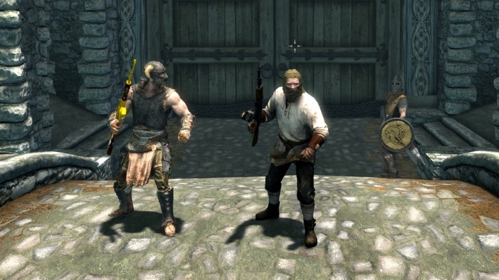 Two nords wield AK-47s in Whiterun, from Skyrim.